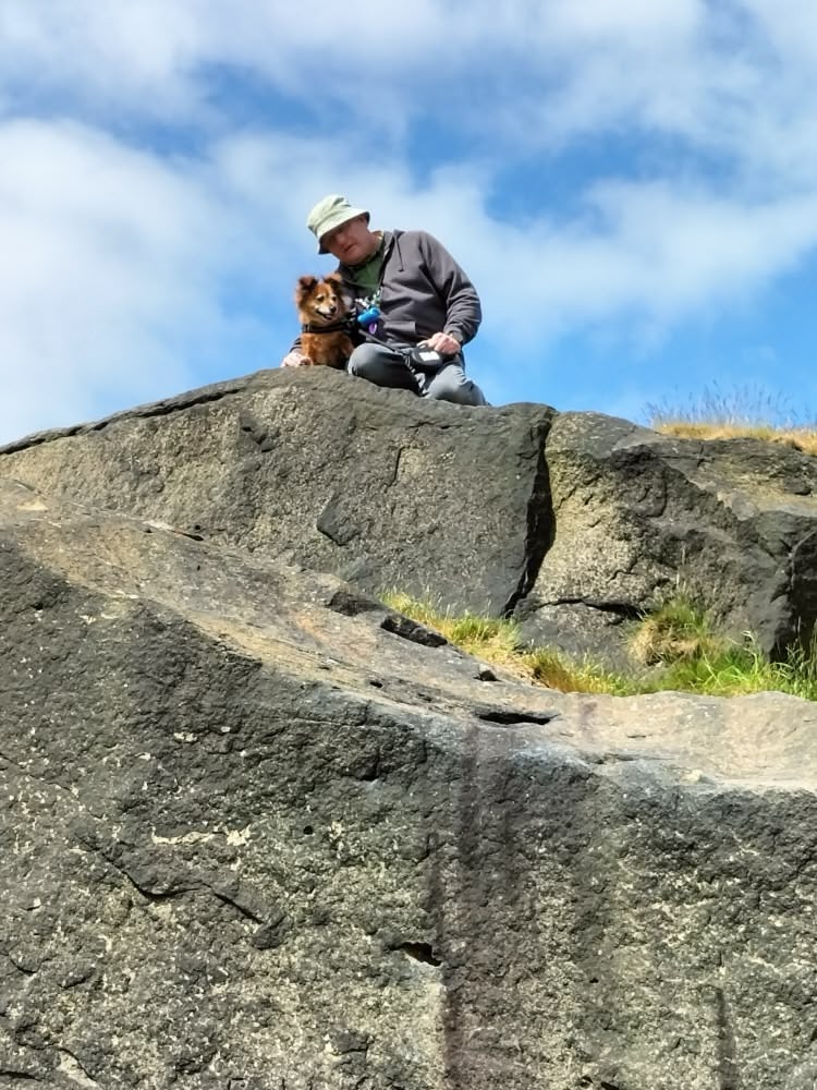 Keith and Enzo resting on a big rock during a walk